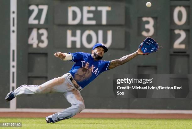 Delino DeShields of the Texas Rangers attempts to catch a double off the bat of Xander Bogaerts of the Boston Red Sox in the sixth inning at Fenway...