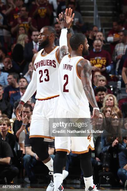 LeBron James and Kyrie Irving of the Cleveland Cavaliers high five during the game against the Boston Celtics in Game Four of the Eastern Conference...