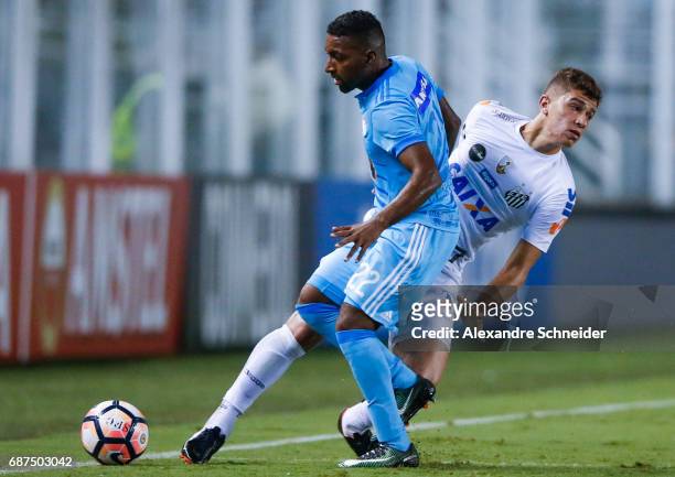 Jair Cespedes of Sporting Cristal of Peru and Vitor Bueno of Santos of Brazil in action during the match between Santos and Sporting Cristal for the...