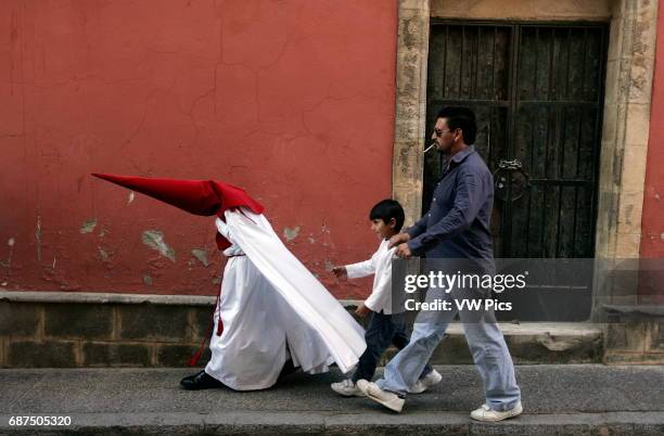 Penitents take part in the El Impertinente brotherhood before the procession during the Holy Week in Jeres de la Fronteira.