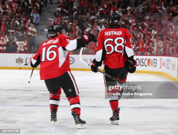 Mike Hoffman of the Ottawa Senators celebrates with teammate Clarke MacArthur after a third period goal on the Pittsburgh Penguins in Game Six of the...