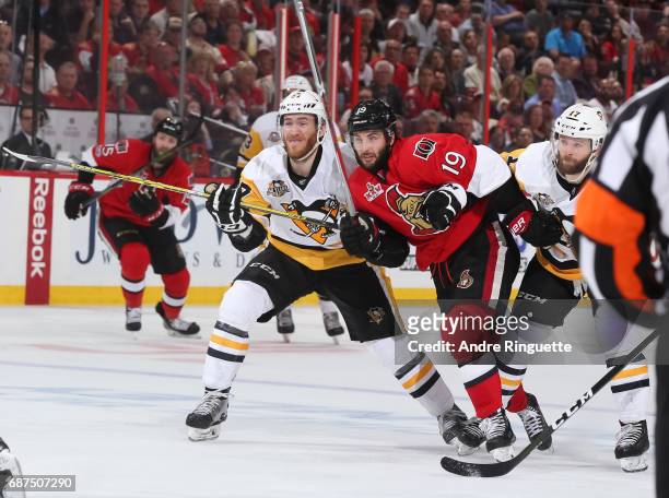 Carter Rowney and Bryan Rust of the Pittsburgh Penguins battle for position with Derick Brassard of the Ottawa Senators in Game Six of the Eastern...