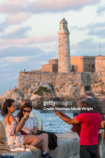 musicians seranade tourists in havana. - malecon stock-fotos und bilder