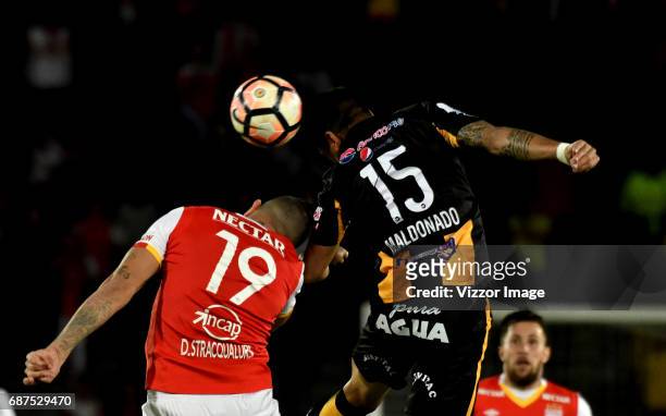 Denis Straqualursi of Independiente Santa Fe, fights for the ball with Luis Maldonado of The Strongest during a match between Independiente Santa Fe...