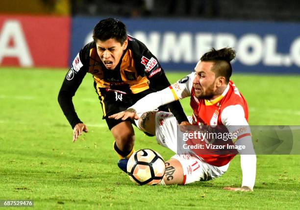 Jonathan Gomez of Independiente Santa Fe, fights for the ball with Diego Wayar of The Strongest during a match between Independiente Santa Fe and The...