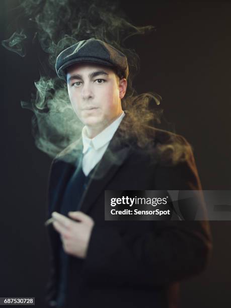 real man smoking in peaky blinders suit - flat cap stock pictures, royalty-free photos & images