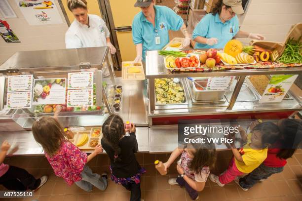 Elementary School Children in line at cafeteria being served healthy lunches Hagerstown, Maryland.