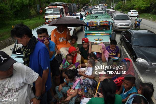 Resident fleeing from Marawi city,where gunmen who had declared allegiance to the Islamic State group rampaged through the southern city, are cramped...