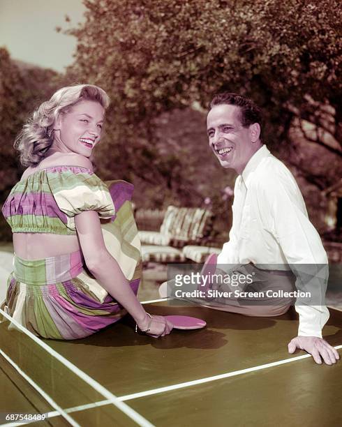 Married American actors Lauren Bacall and Humphrey Bogart playing table tennis, circa 1950.
