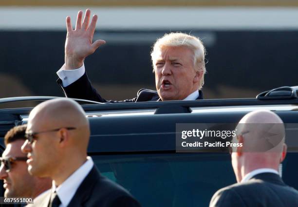 President Donald Trump waves to reporters after disembarking from Air Force One at Fiumicino international airport. Trump will meet Pope Francis, at...