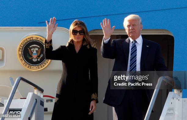 President Donald Trump, right, and his wife Melania disembark from Air Force One at Fiumicino international airport. Trump will meet Pope Francis, at...