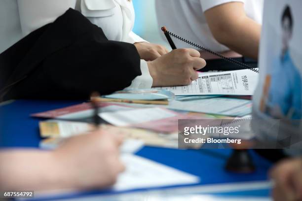 Jobseekers fill out application forms at a job fair in Incheon, South Korea, on Wednesday, May 24, 2017. South Korea is scheduled to release...