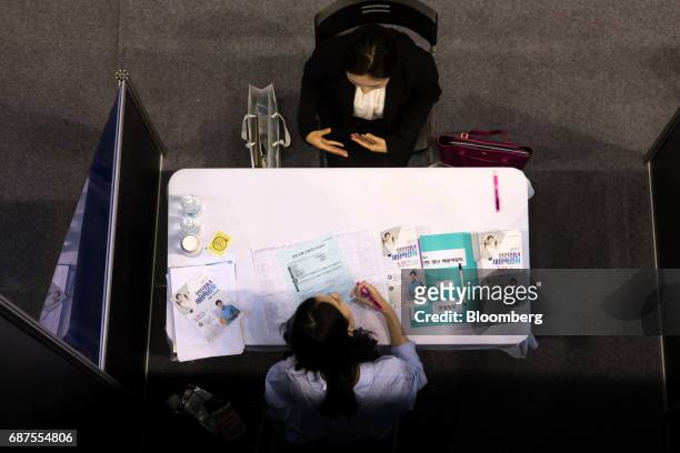 Jobseeker, top, speaks with a job consultant at a job fair in Incheon, South Korea, on Wednesday, May 24, 2017. South Korea is scheduled to release...