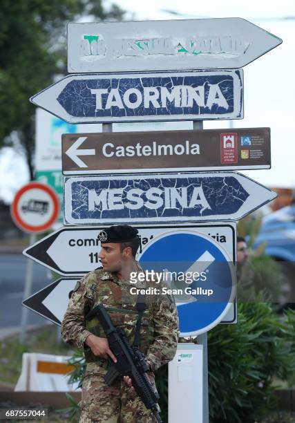 Italian soldier stands at a checkpoint at a road leading up to the historic town of Taormina, which will host the upcoming G7 summit, on the island...