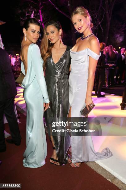 Georgia Fowler, fashion designer Siran Manoukian and Toni Garrn wearing a dress by Siran Manoukian during the DeGrisogono "Love On The Rocks" gala...