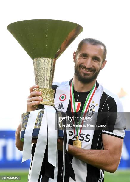 Giorgio Chiellini of Juventus FC celebrates with the trophy after the beating FC Crotone 3-0 to win the Serie A Championships at the end of the Serie...