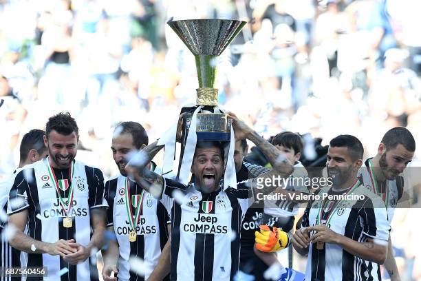 Daniel Alves of Juventus FC celebrates with the trophy after the beating FC Crotone 3-0 to win the Serie A Championships at the end of the Serie A...