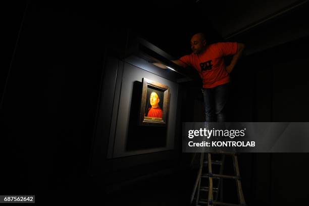 Workers and technicians prepares the exhibition "Portrait of Men" by Antonello da Messina at Palazzo Zevallos/Gallerie d'Italia.