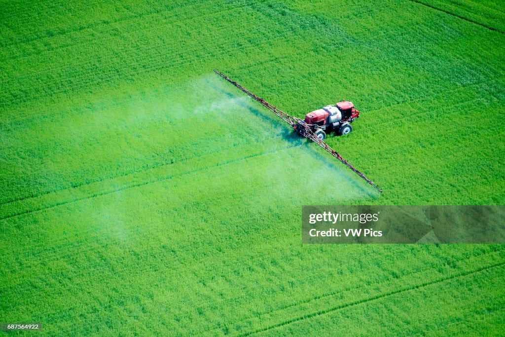 Aerial of spray application in green agricultural field on the eastern shore of Maryland, USA
