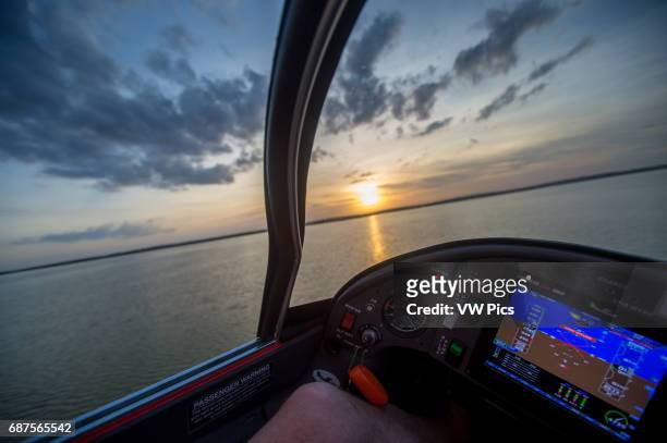 Instrument of seaplane while flying above water at sunset in Southeastern USA.