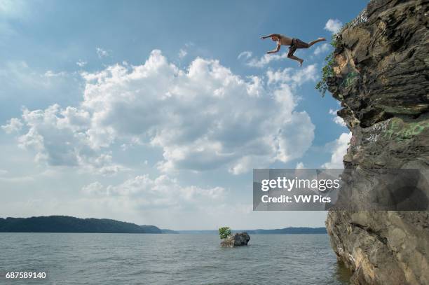 Cliff diver falling into the water in Maryland near Mason Dixon line.