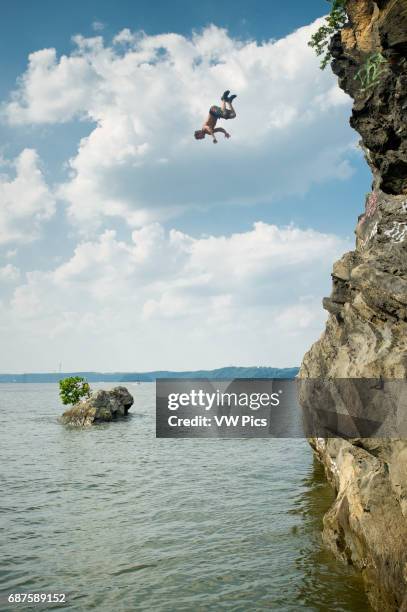 Cliff diver falling into the water in Maryland near Mason Dixon line.
