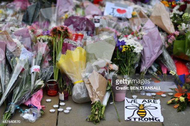 Flowers and candles are pictured in St Ann's Square in Manchester, northwest England on May 24 placed in tribute to the victims of the May 22 terror...