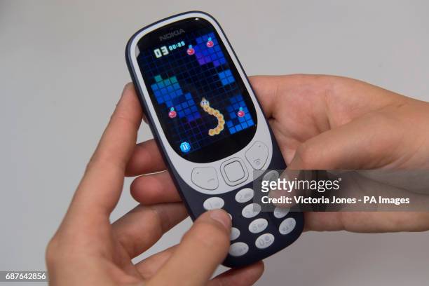 Person plays the classic mobile game Snake as the new Nokia 3310 mobile phone goes on sale at the Carphone Warehouse on Oxford Street, London.