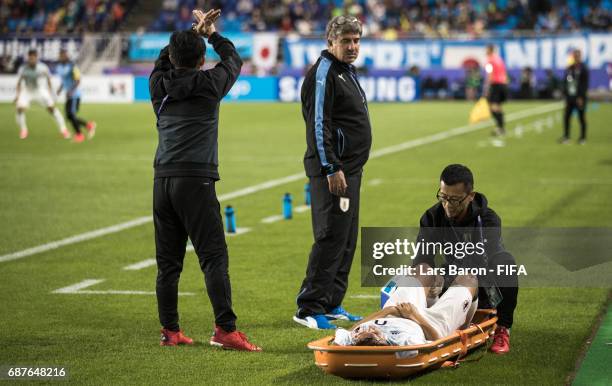 Koki Ogawa of Japan lies injured next to the pitch during the FIFA U-20 World Cup Korea Republic 2017 group D match between Uruguay and Japan at...