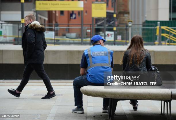 Response pastor , deployed into the community following a disaster or crisis, talks with a woman near Albert Square in Manchester, northwest England...