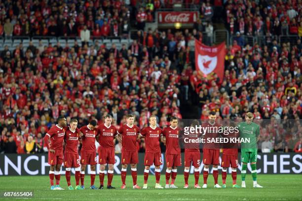 Liverpool players observe a minute's silence for victims of the Manchester terror attack during their end-of-season friendly football match against...