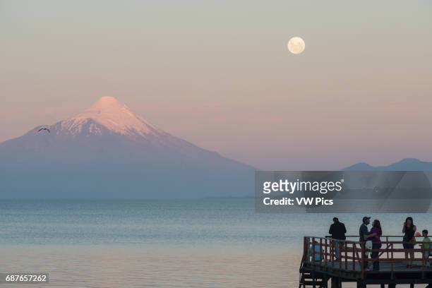 Moonrise, Puerto Varas, Chile with Osorno Volcano and Llanquihue Lake.