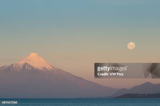 Moonrise, Puerto Varas, Chile with Osorno Volcano and Llanquihue Lake.