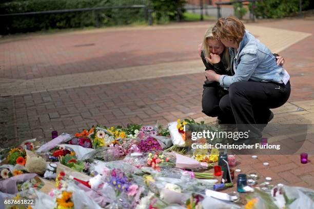 People react as they lay lowers in the centre of the Lancashire village of Tarleton, the home village of Georgina Callander and Saffie Rose Roussos...