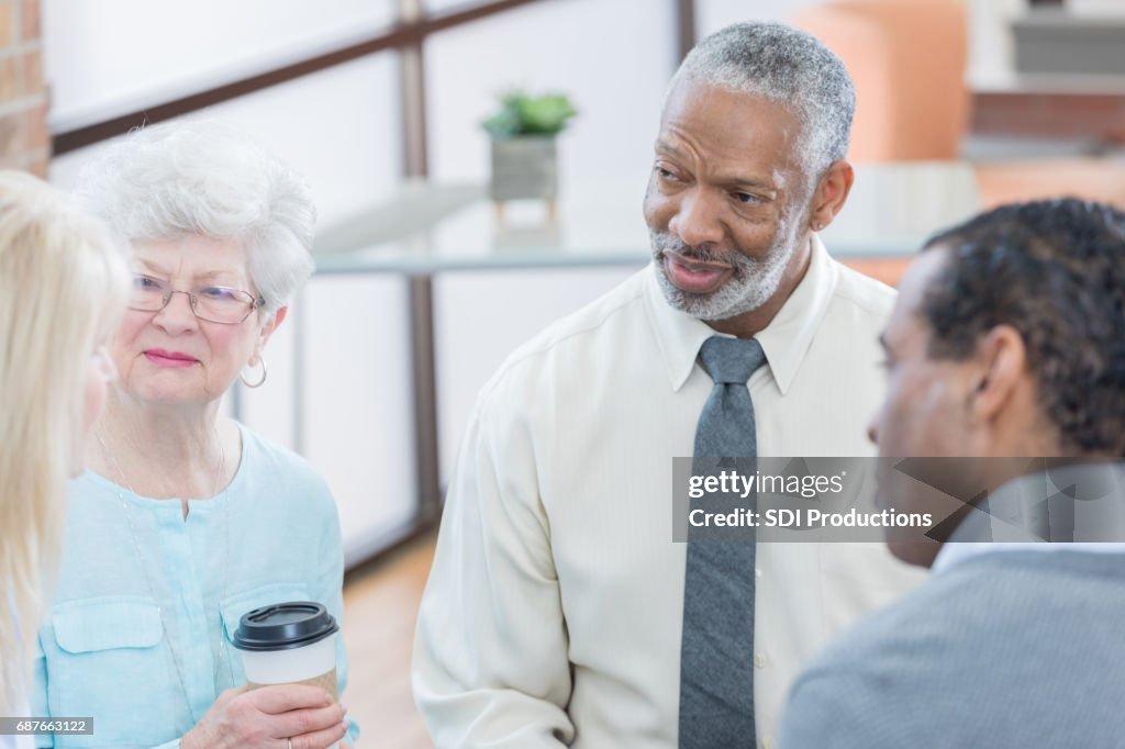 Senior adults discuss something at support group meeting
