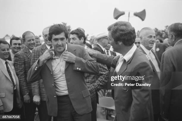 Augusta,GA April 13th 1980, Seve Ballesteros receives the green jacket from the 1979 champion Fuzzy Zoeller of the USA after the final round of the...