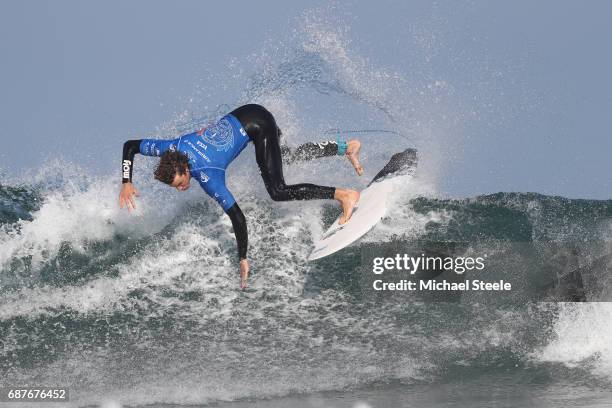 Robert Webster Blythe of Wales falls from his board whilst competing in the Men's Repechage Round 1 during day five of the ISA World Surfing Games...