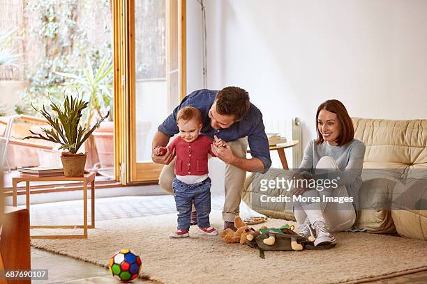 parents with baby enjoying at home - leanintogether stock pictures, royalty-free photos & images