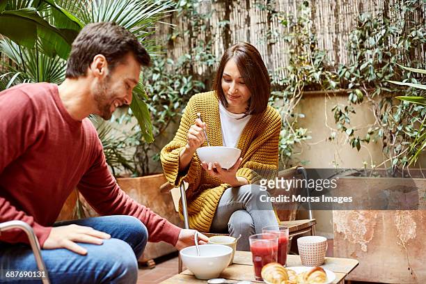 mid adult couple having breakfast in yard - breakfast woman bildbanksfoton och bilder