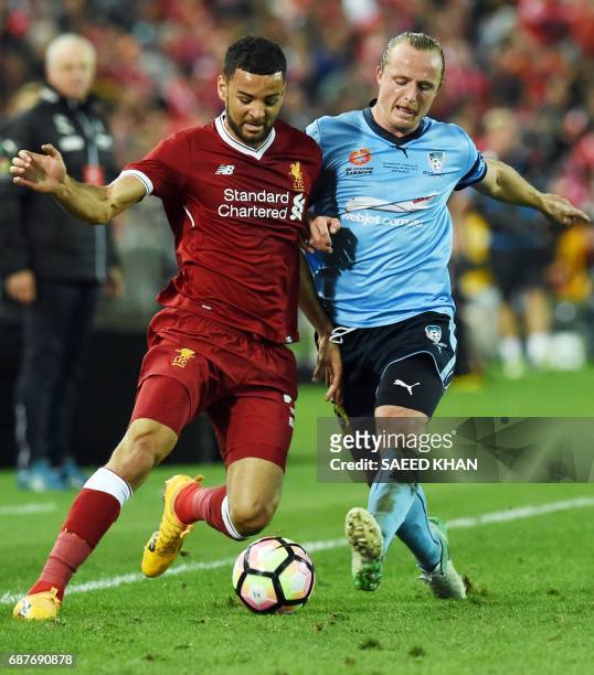 Liverpool's Kevin Stewart and Sydney FC player Rhyan Grant fight for ball during their end-of-season friendly football match at the Olympic Stadium...