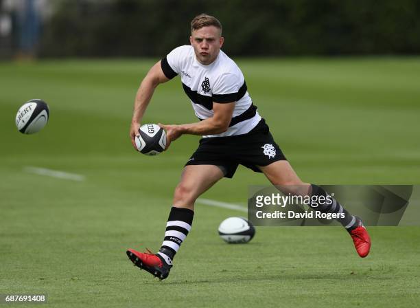 Ian Madigan runs with the ball during the Barbarians training session held at Latymers School on May 24, 2017 in London, England.