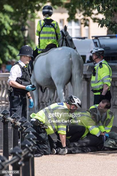 Man is detained by police near Buckingham Palace on May 24, 2017 in London, United Kingdom. The Changing of the Guard ceremony has been cancelled...