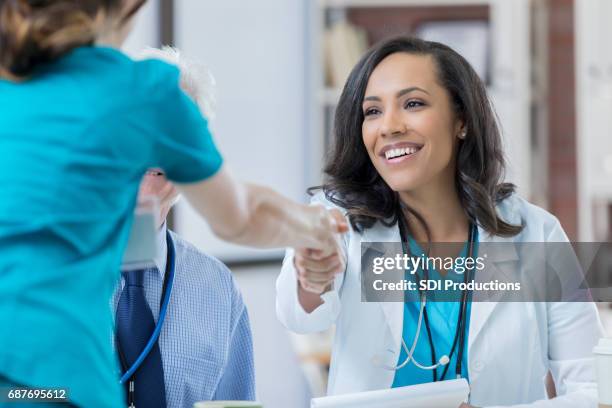 confident doctor interviews nurse - medical administrator stock pictures, royalty-free photos & images