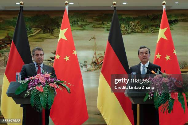 Chinese Foreign Minister Wang Yi with German Foreign Minister Sigmar Gabriel attends a press conference at the foreign ministry on May 24, 2017 in...