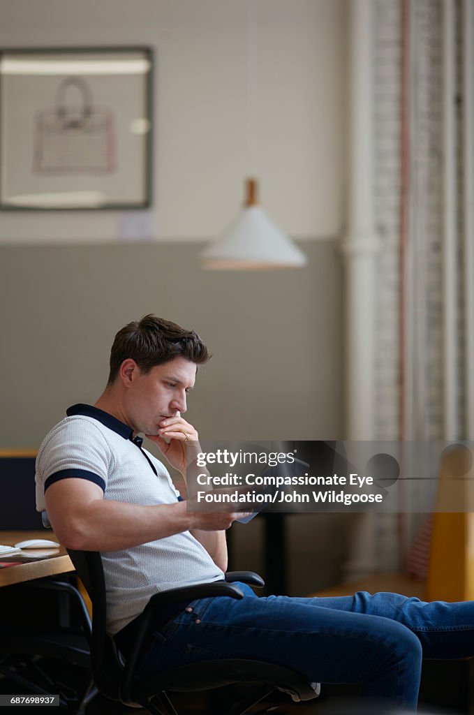 Businessman using digital tablet in office