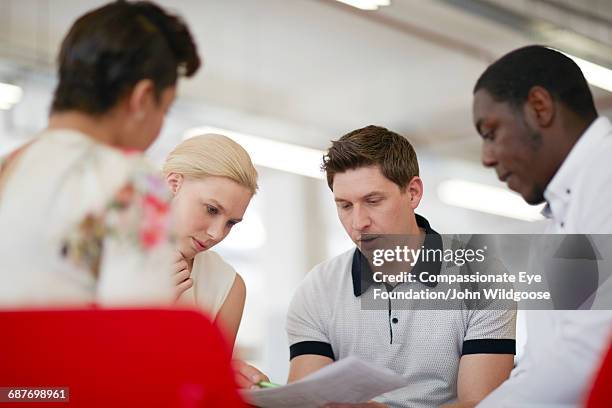 business people reviewing proofs in office - market research stock pictures, royalty-free photos & images