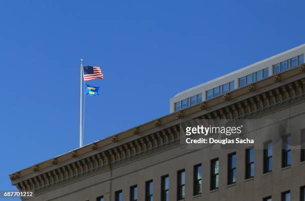 us national and human rights campaign flags flying on an office building flag pole - human rights watch stock pictures, royalty-free photos & images