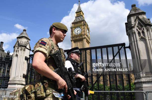 British Army soldier patrols with an armed police officer near the Houses of Parliament in central London on May 24, 2017. Britain deployed soldiers...