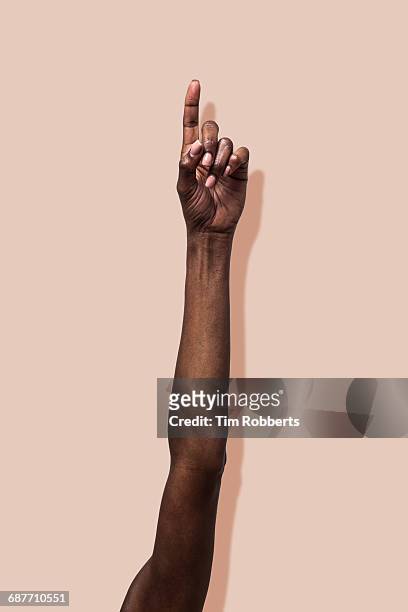 woman raising hand in the air. - menschlicher arm stock-fotos und bilder
