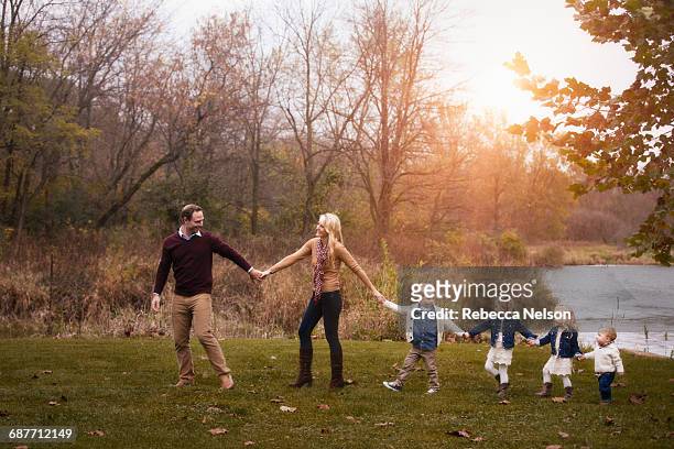 family, holding hands, walking forward in line - large family ストックフォトと画像